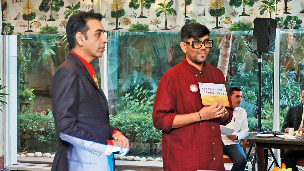 Siddhant Shah (in red) decodes Braille using a tool