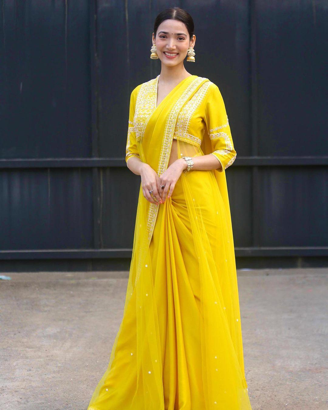 With a flair for sarees, Medha dons a lovely yellow saree with intricate white embroidery