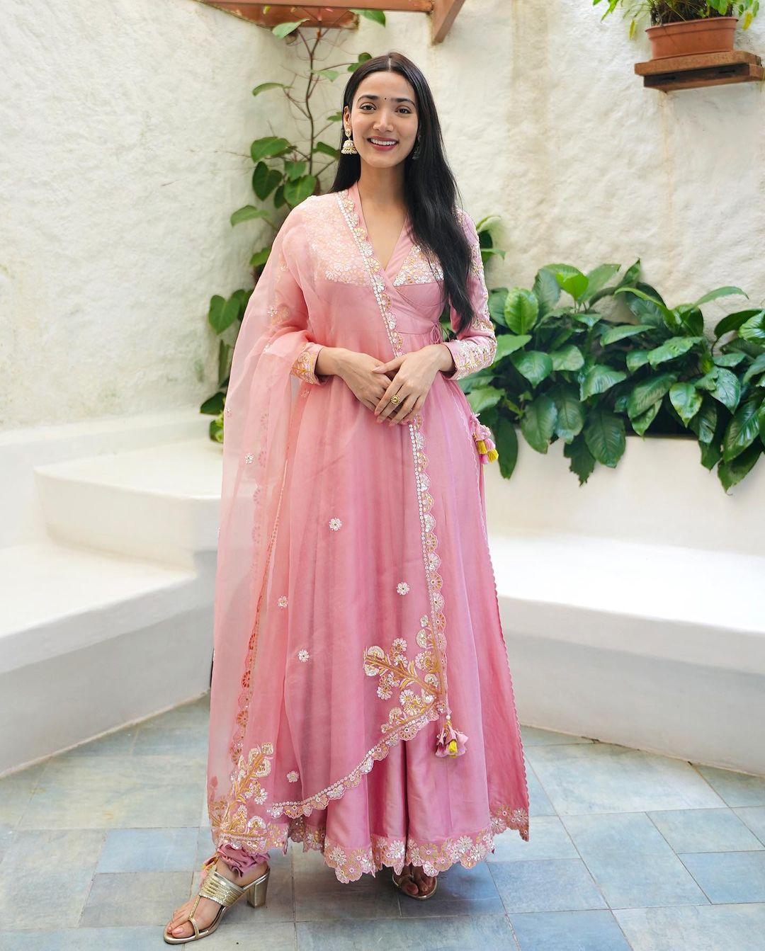 Radiating beauty, Medha wears a stunning pink suit adorned with intricate designs