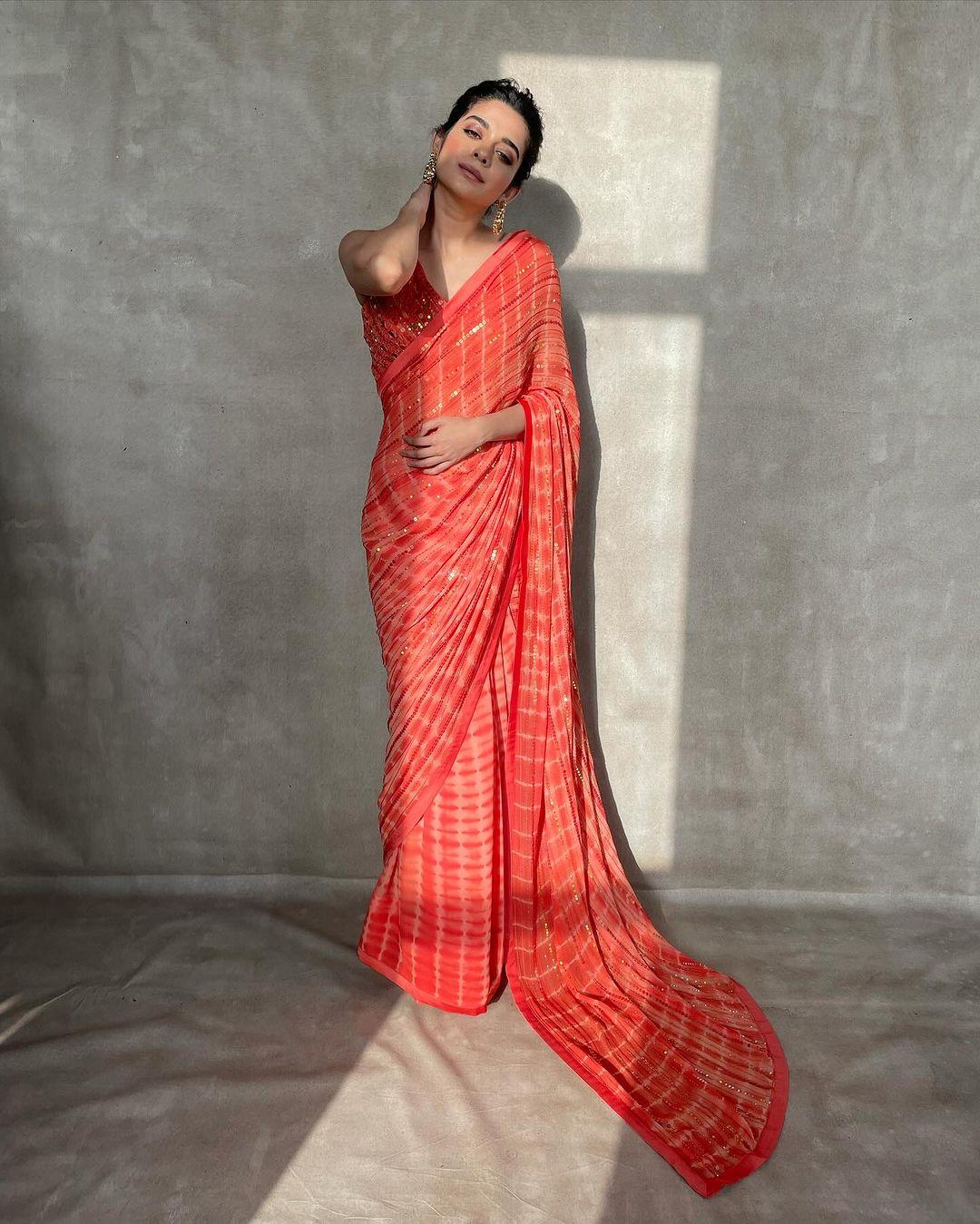 Mithila captivates in an orange saree paired with a matching blouse adorned with mirrorwork