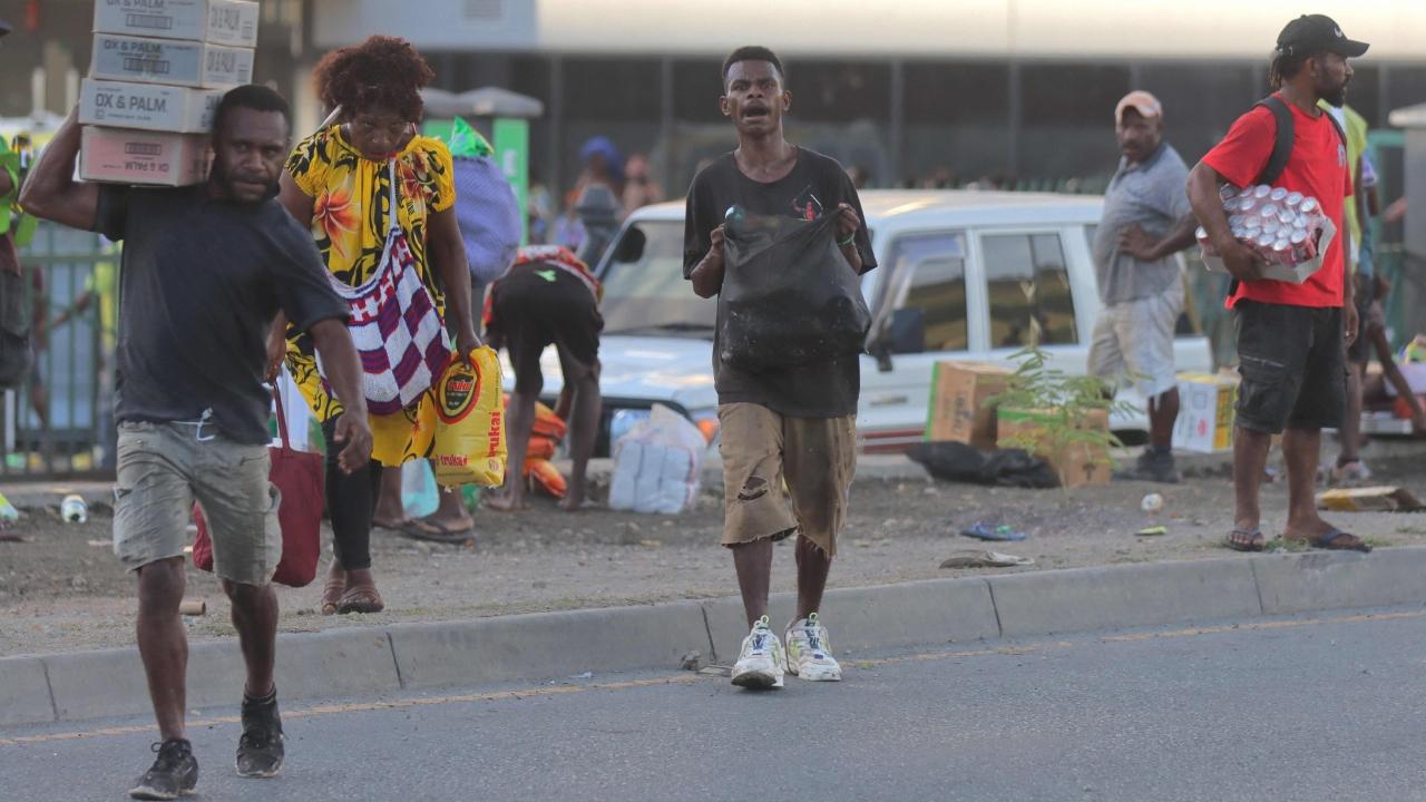 The unrest began in the capital, Port Moresby, on Wednesday after hundreds of police officers, soldiers, prison staff and public servants walked off their jobs in protest over a pay dispute