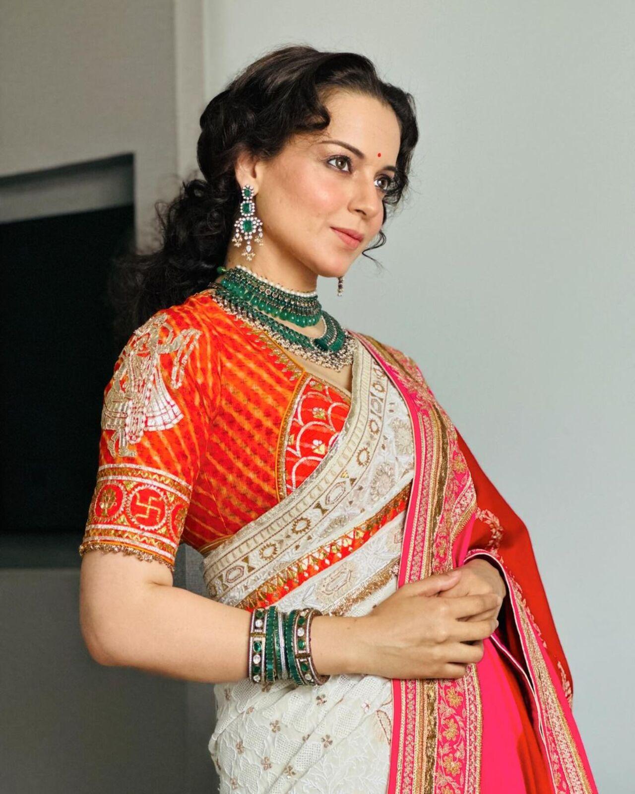 She was seen dressed in a gorgeous saree. Kangana paired the orange and white saree with contrasting green jewellery