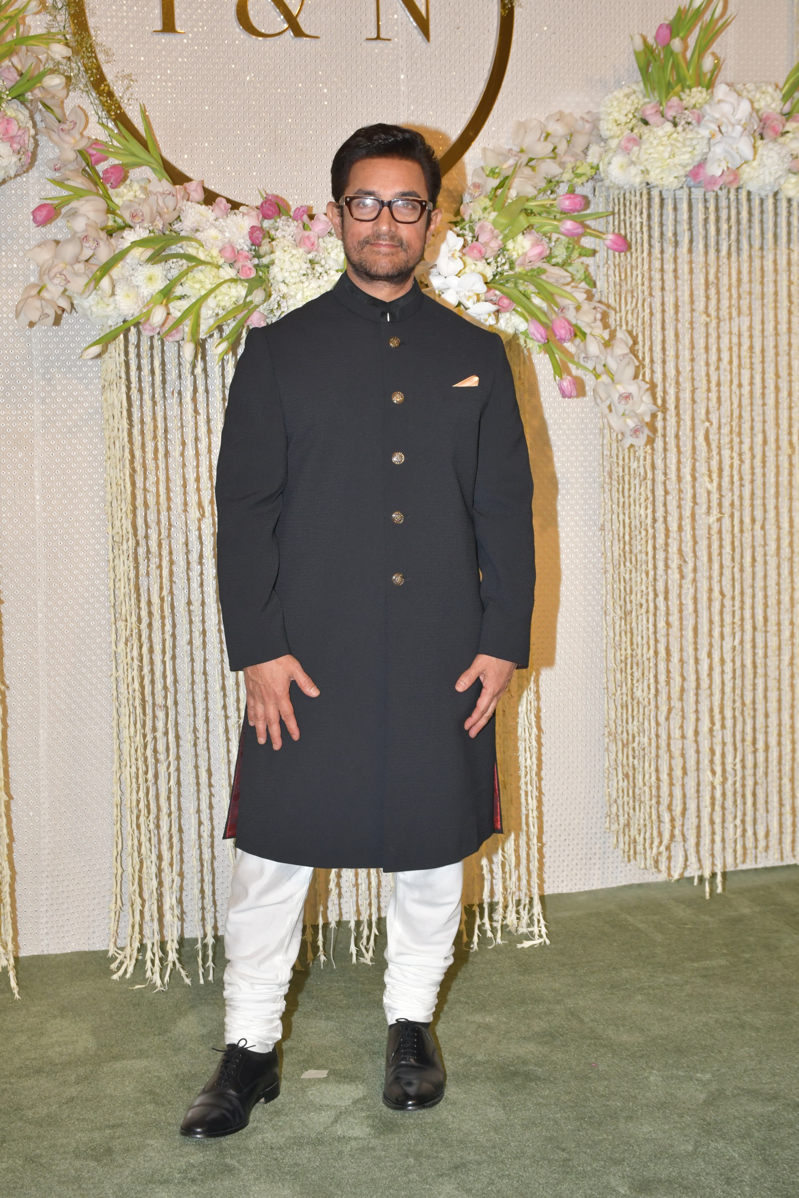 Proud father Aamir Khan, adorned in a black nawabi outfit, radiates pure joy. Oh my, he looks so happy!