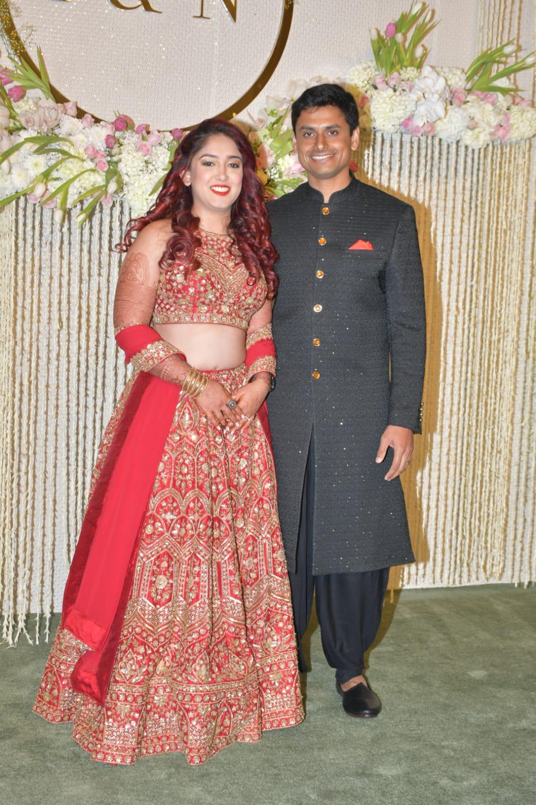 Ira Khan and Nupur Shikhare, looking absolutely stunning in their reception outfits. Ira, in a red lehenga, exudes a princess vibe straight out of a Disney movie, while Nupur, dressed in a black sherwani, resembles a handsome prince