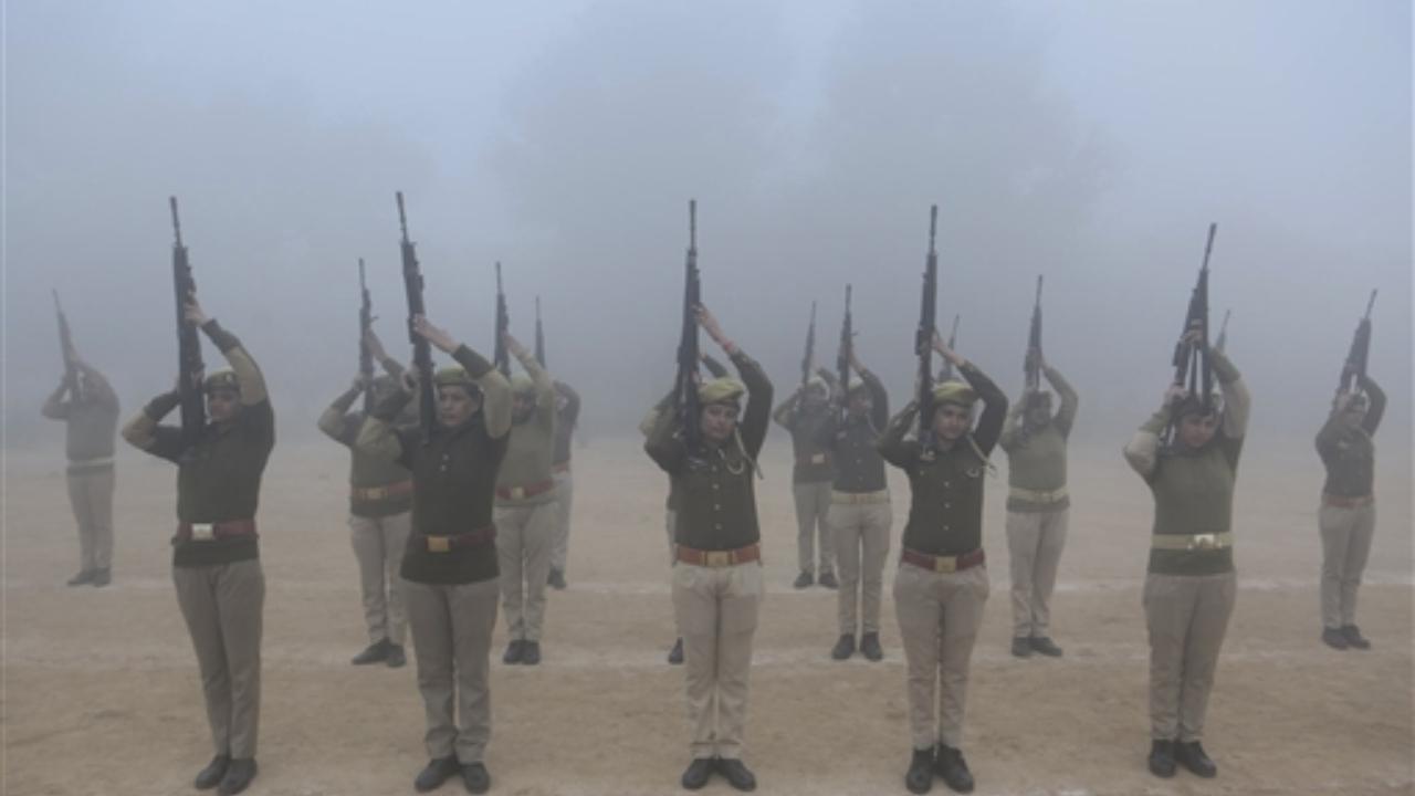 Women police personnel during rehearsal for the Republic Day Parade 2024 amid morning fog, in Mathura on Saturday