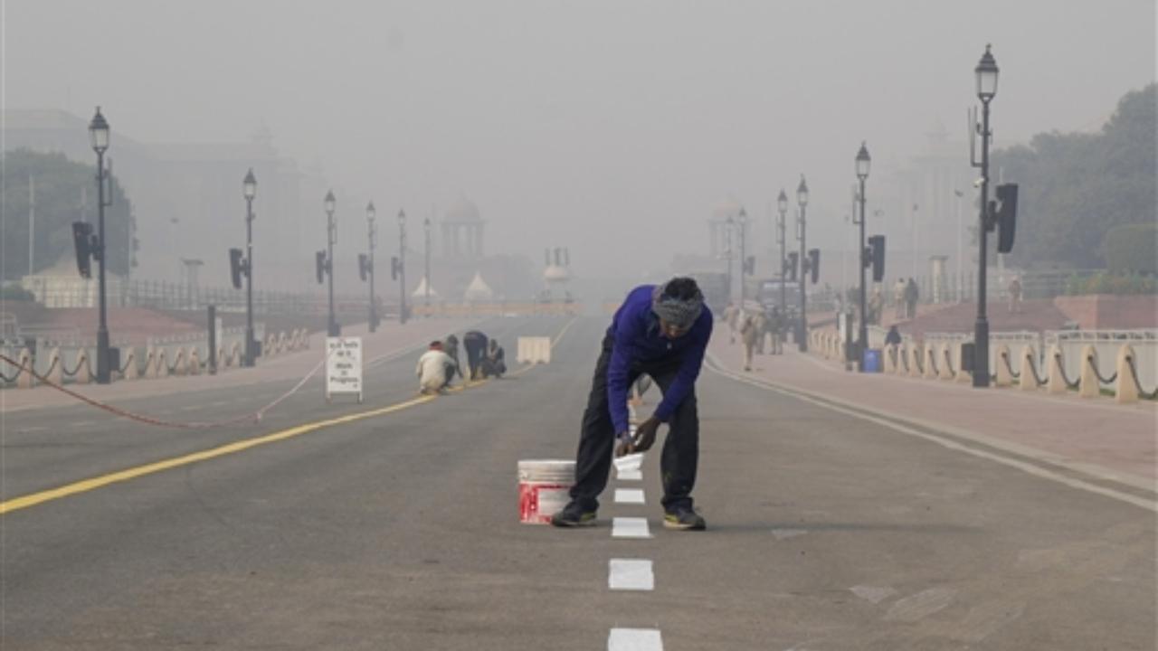 Preparations underway on Kartavya Path for the Republic Day Parade 2024 during a cold and foggy winter morning