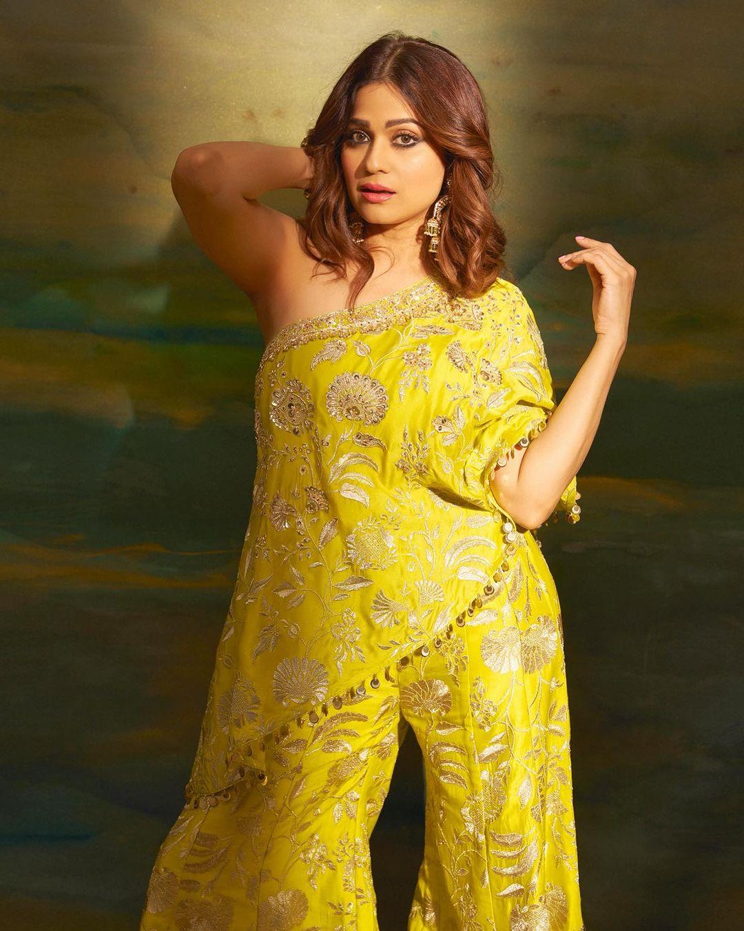 Adorned with golden prints, she opts for nude makeup, leaving her hair in soft curls