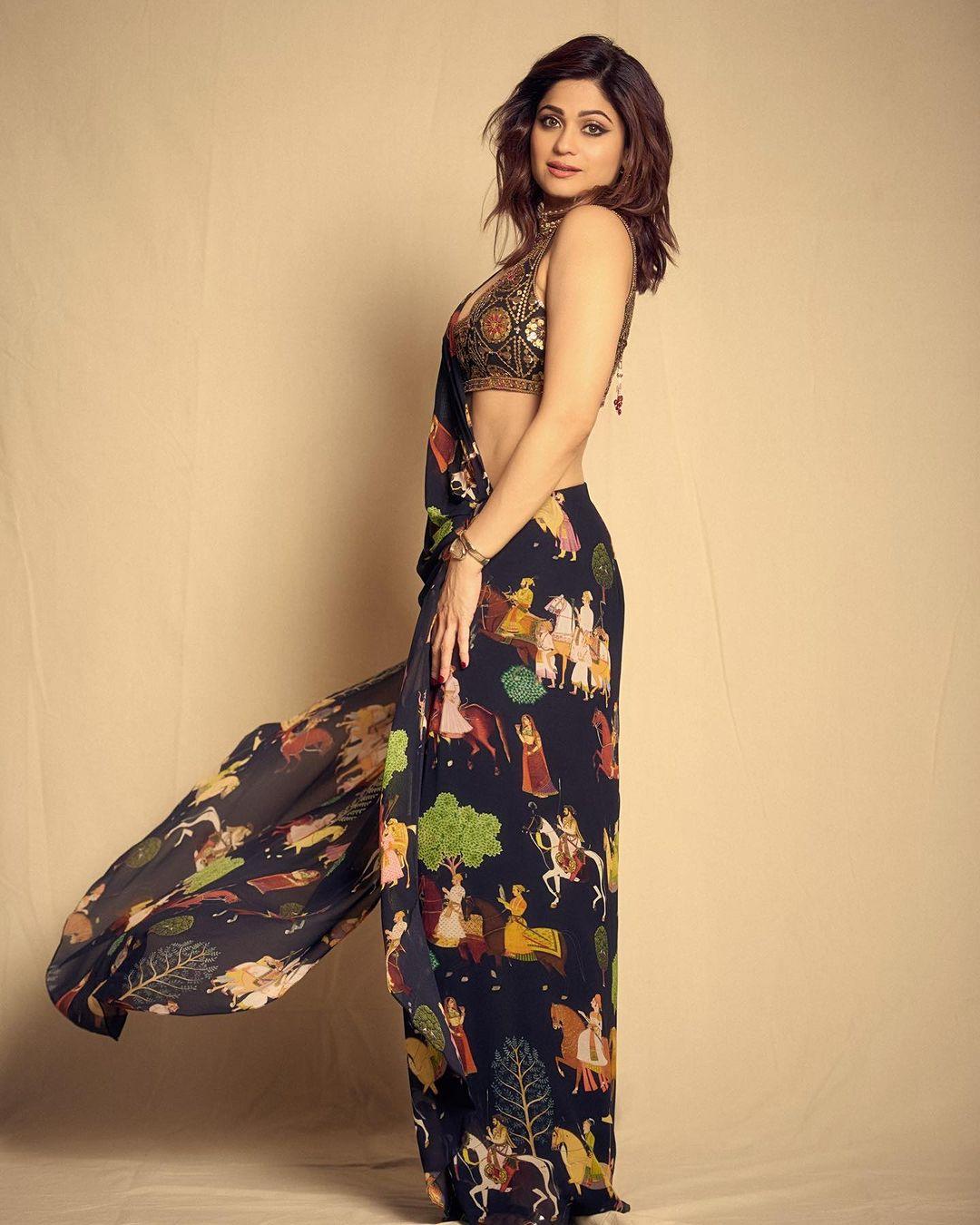 Sarees are Shamita's forte, evident in her beautiful dark blue saree adorned with unique people prints