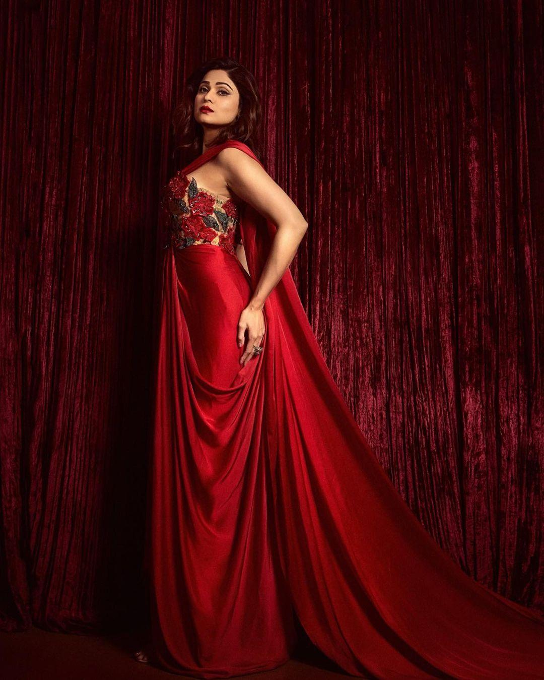 The long trail and bold red lipstick enhance the glamour