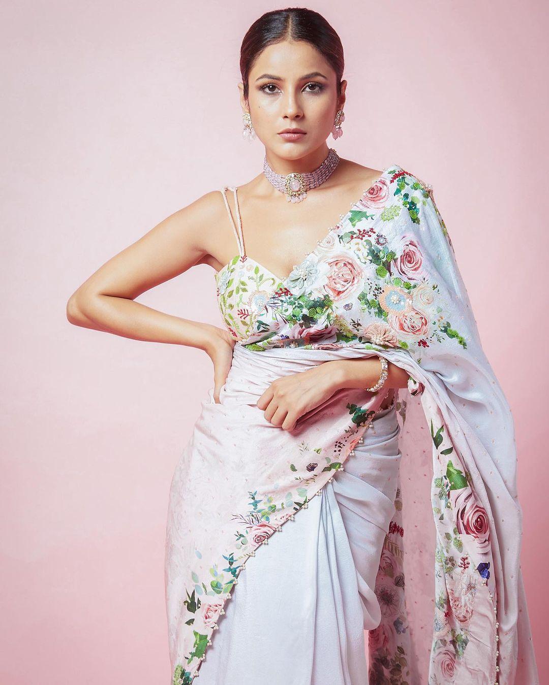 The diamond necklace and matching earrings add a touch of sophistication, and her minimal makeup enhances her natural beauty. This look is perfect for any occasion, showcasing Shehnaaz's timeless grace