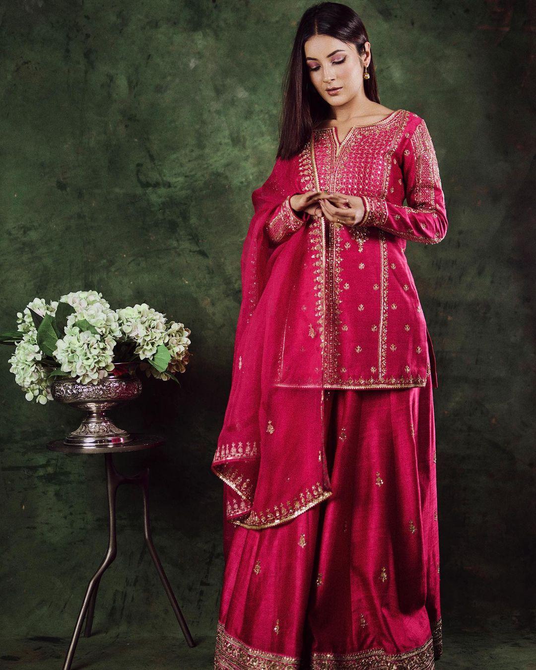 Red is a timeless choice that effortlessly adapts to any occasion. Shehnaaz showcases its universal appeal by elegantly pairing an embroidered kurta with matching palazzo pants and a dupatta