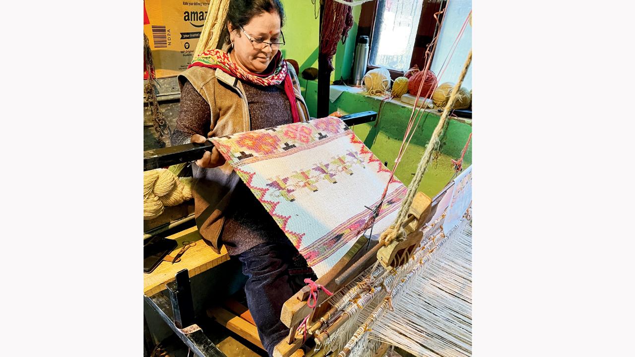Kullvi Whims started as a self-help group with nine women artisans. A weaver from Naggar in HP works on a hand-spun wool rug