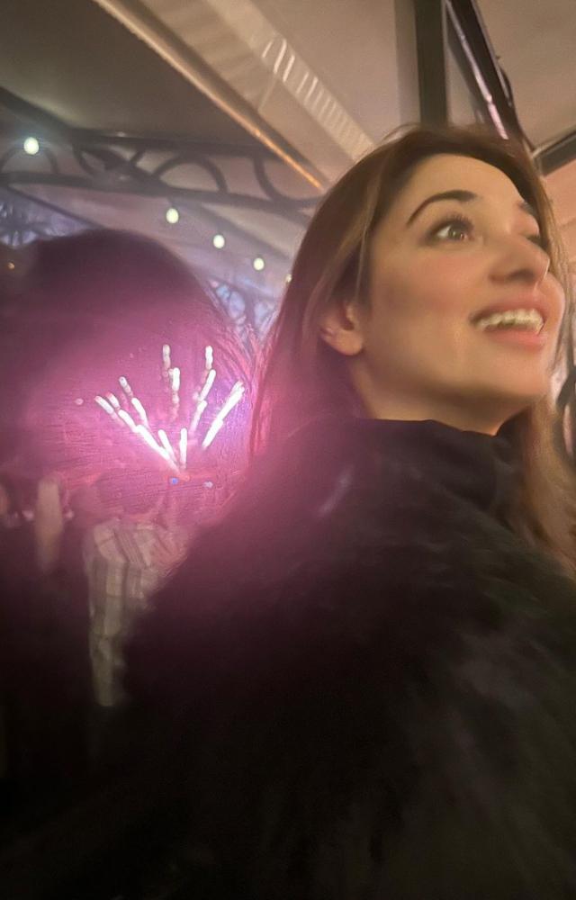 Fireworks can be seen in the background of this picture as Tamannaah relishes the moment