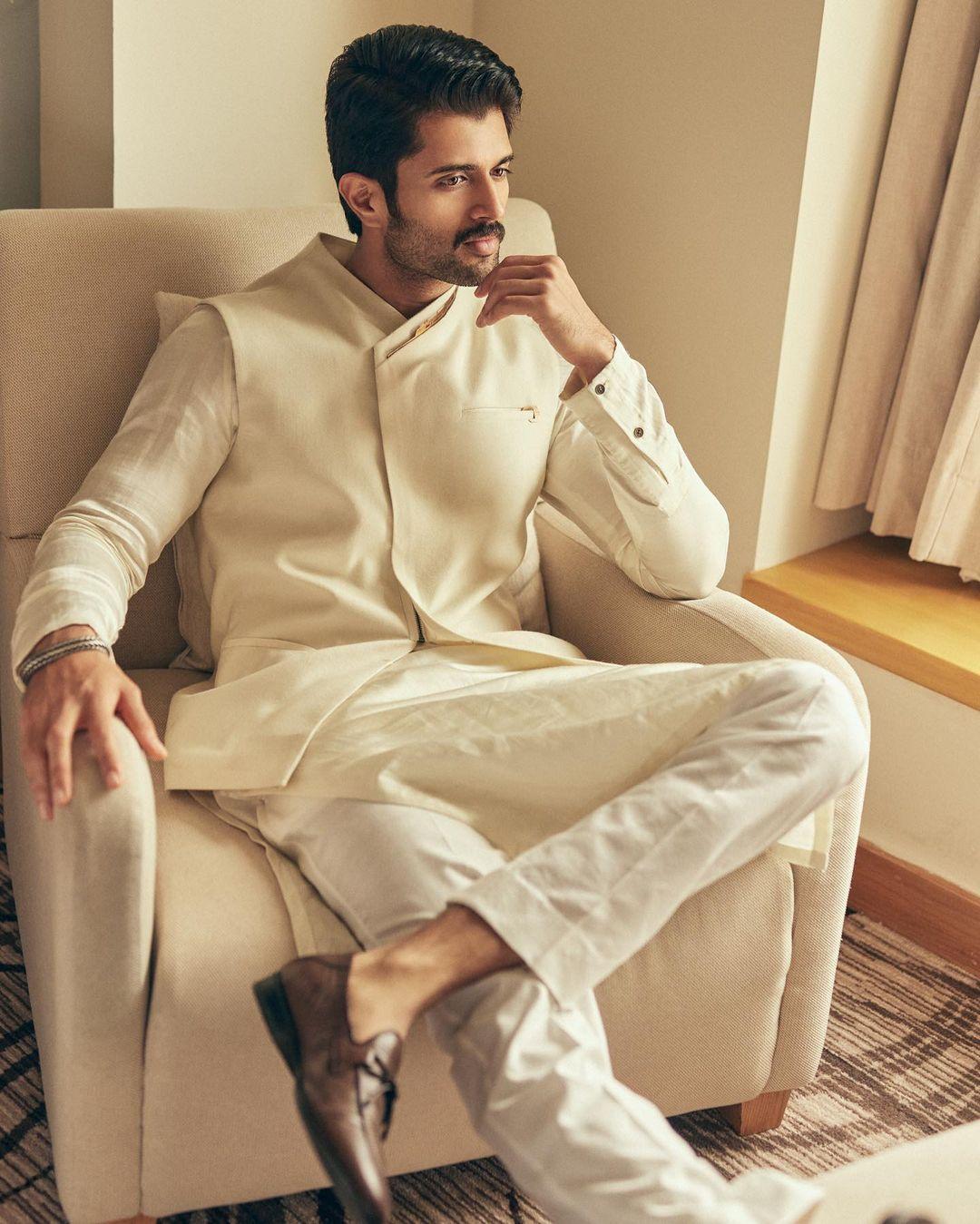 Vijay exudes unparalleled charm and style in his all-white ensemble, effortlessly paired with striking brown shoes for the perfect contrast