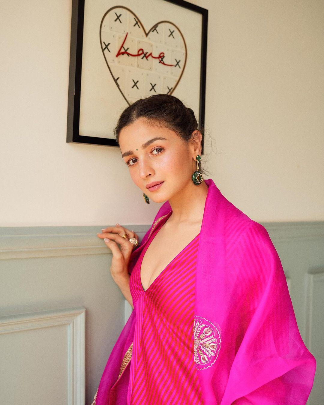 Alia Bhatt's outfit is simply perfect for Lohri, showcasing a beautiful rani pink kurta detailed with vertical lines and paired with a chiffon dupatta adorned with floral zari embroidery. 