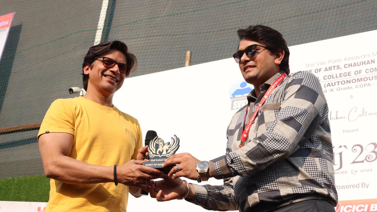 Capturing the essence of a vibrant exchange, Shaan stands poised and grateful as he receives a commemorative memento following an enriching conversation session at Mithibai Kshitij, a snapshot of insightful dialogue and memorable moments that linger in the air