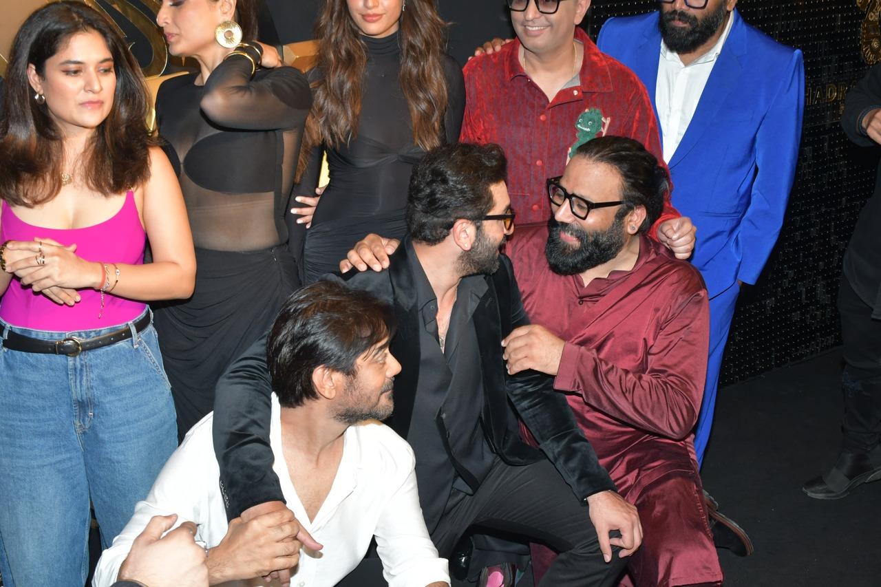 Director Sandeep Reddy Vanga and Ranbir Kapoor have a quick happy chat before they pose together with the team for the paparazzi