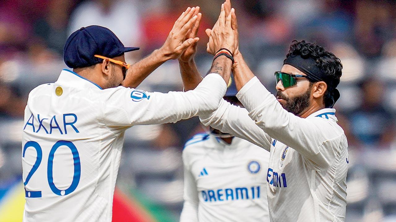 India’s Ravindra Jadeja (right) with teammate Axar Patel after the dismissal of England’s Tom Hartley. Pic/PTI