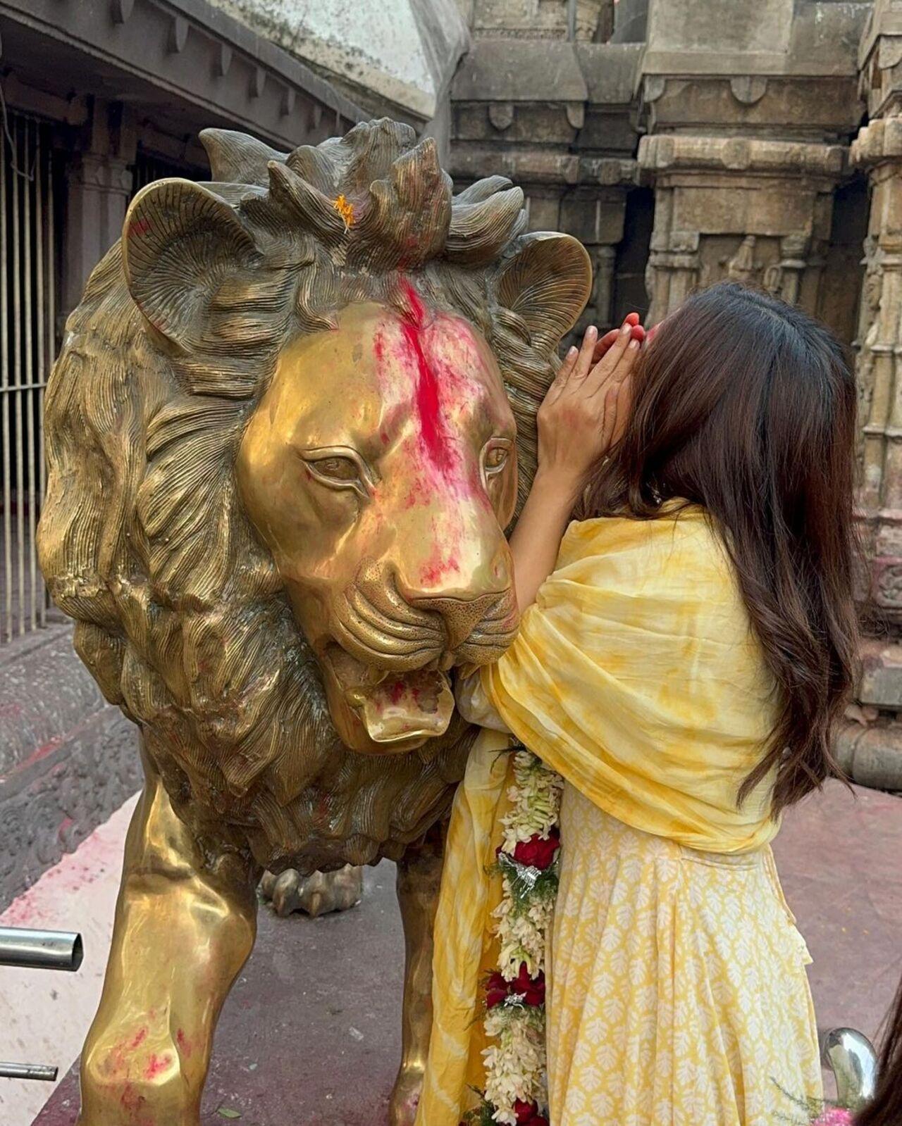 Bhumi Pednekar whispers in the ear of a lion idol. It is said that wishes whispered in the ear of the lion is fulfilled by the Goddess