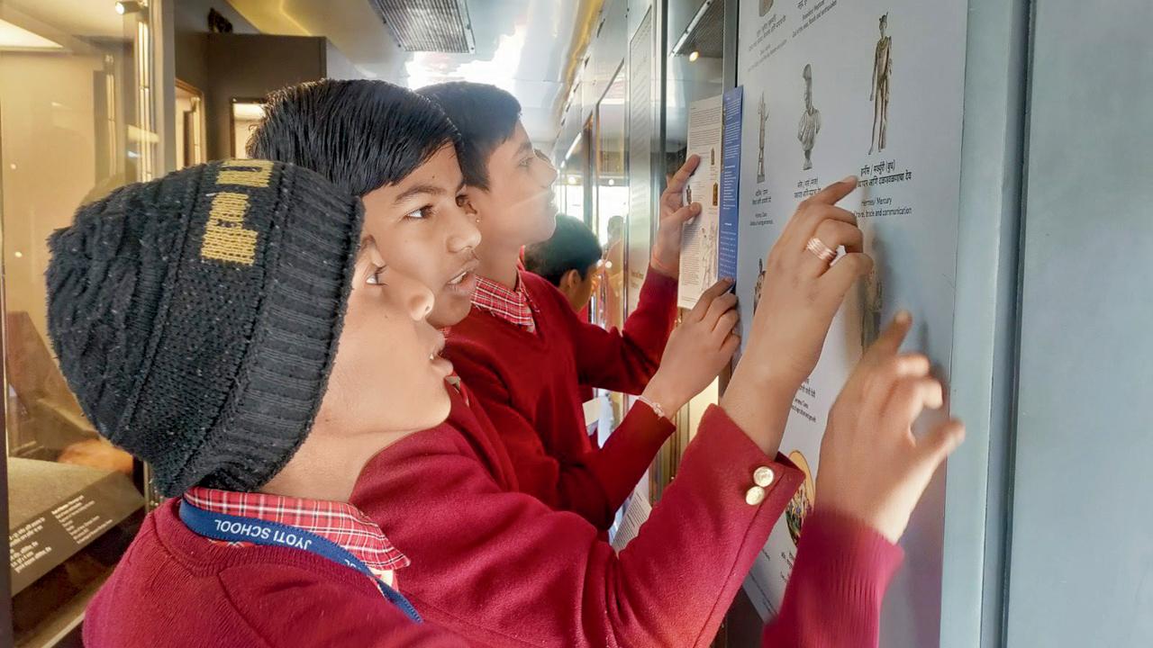 Students explore the exhibits inside the museum bus 