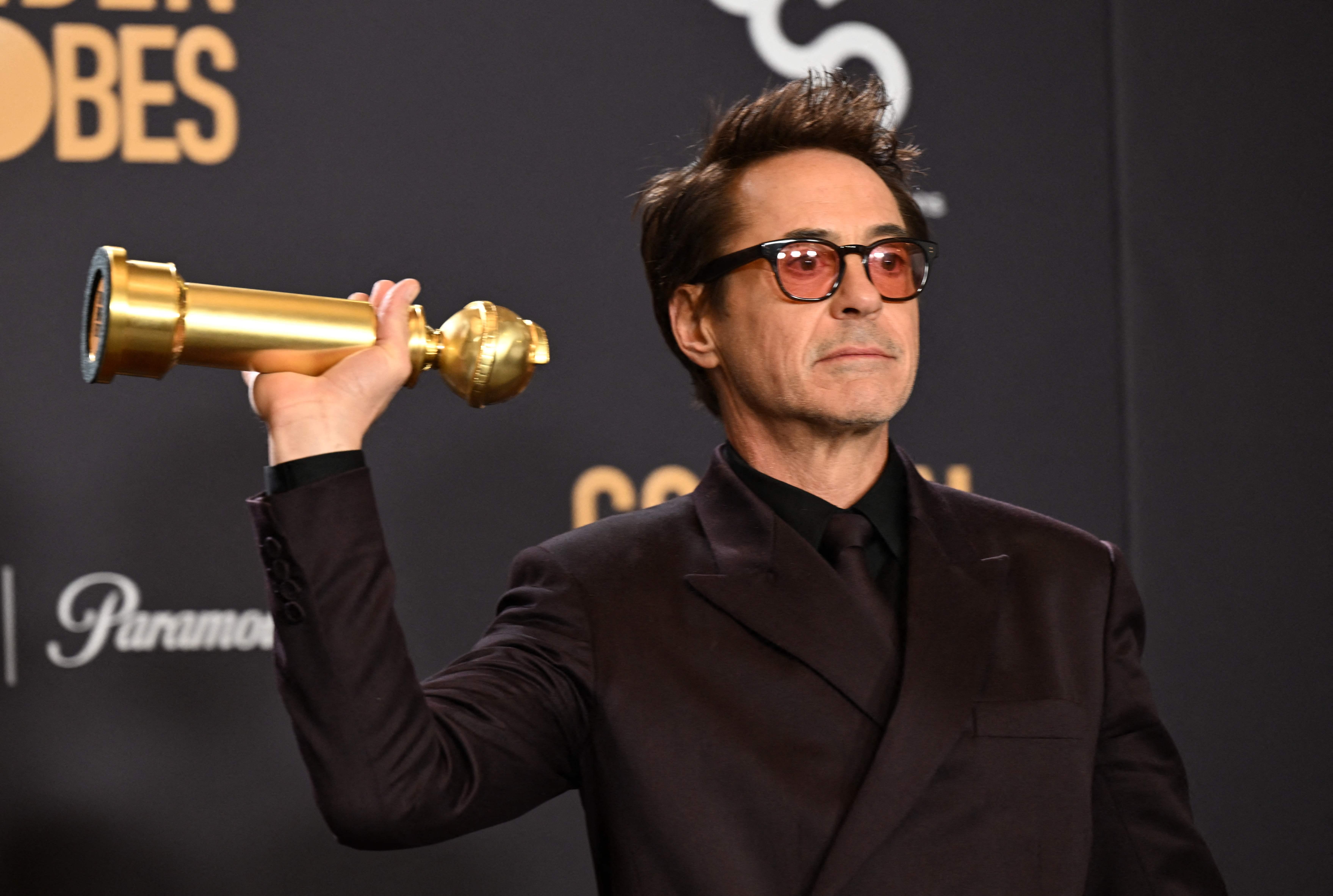Robert Downey Jr. poses with the award for Best Performance by a Male Actor in a Supporting Role in any Motion Picture for 'Oppenheimer' during the 81st annual Golden Globe Awards 