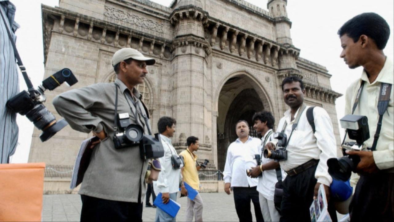 For decades, the photographers at Gateway of India have been an intrinsic part of Mumbai's tourism. Sadly, due to smartphones, these photographers are going out of focus. Photo Courtesy: AFP