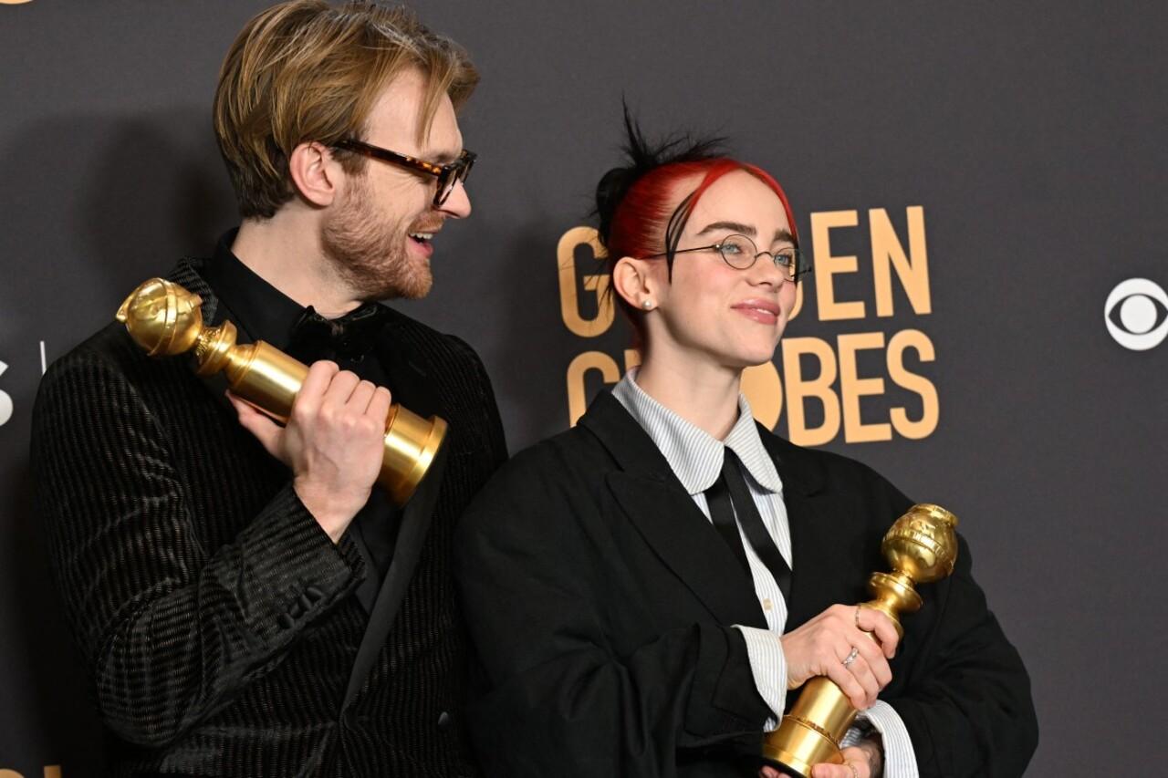 Musicians Billie Eilish (R) and Finneas O'Connell pose with the award for Best Original Song - Motion Picture 