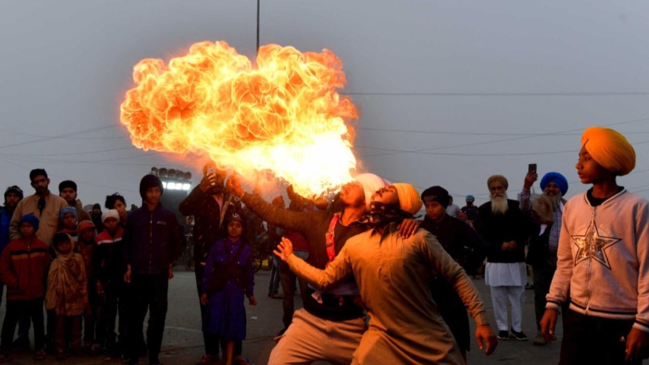 People perform Sikh martial arts on the occasion of the birth anniversary celebrations of the tenth Guru of the Sikhs, Guru Gobind Singh. Image Credits: AFP