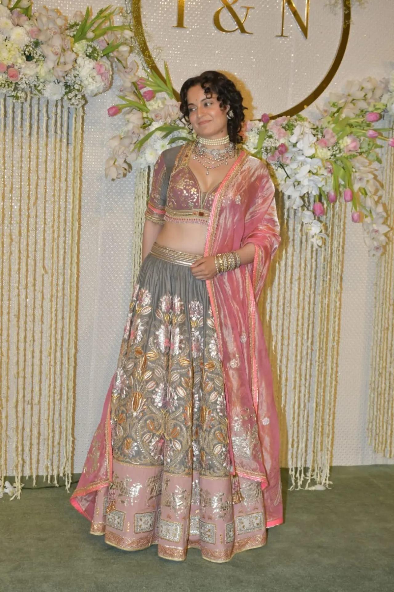 Kangana Ranaut looked beautiful in a heavy grey and pink lehenga. She tied her hair in a loose bun and let her curls frame her face