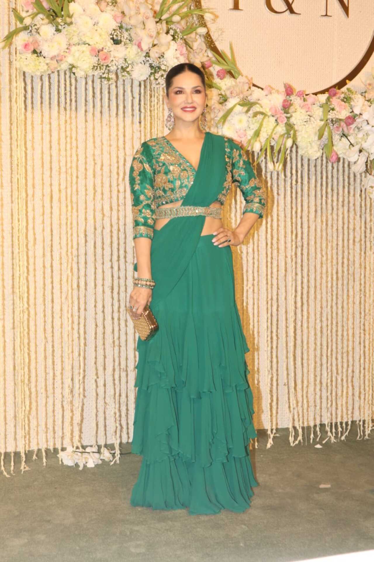 Sunny Leone looked lovely in this bright green saree with a stunning blouse. She completed the saree look with a thick belt