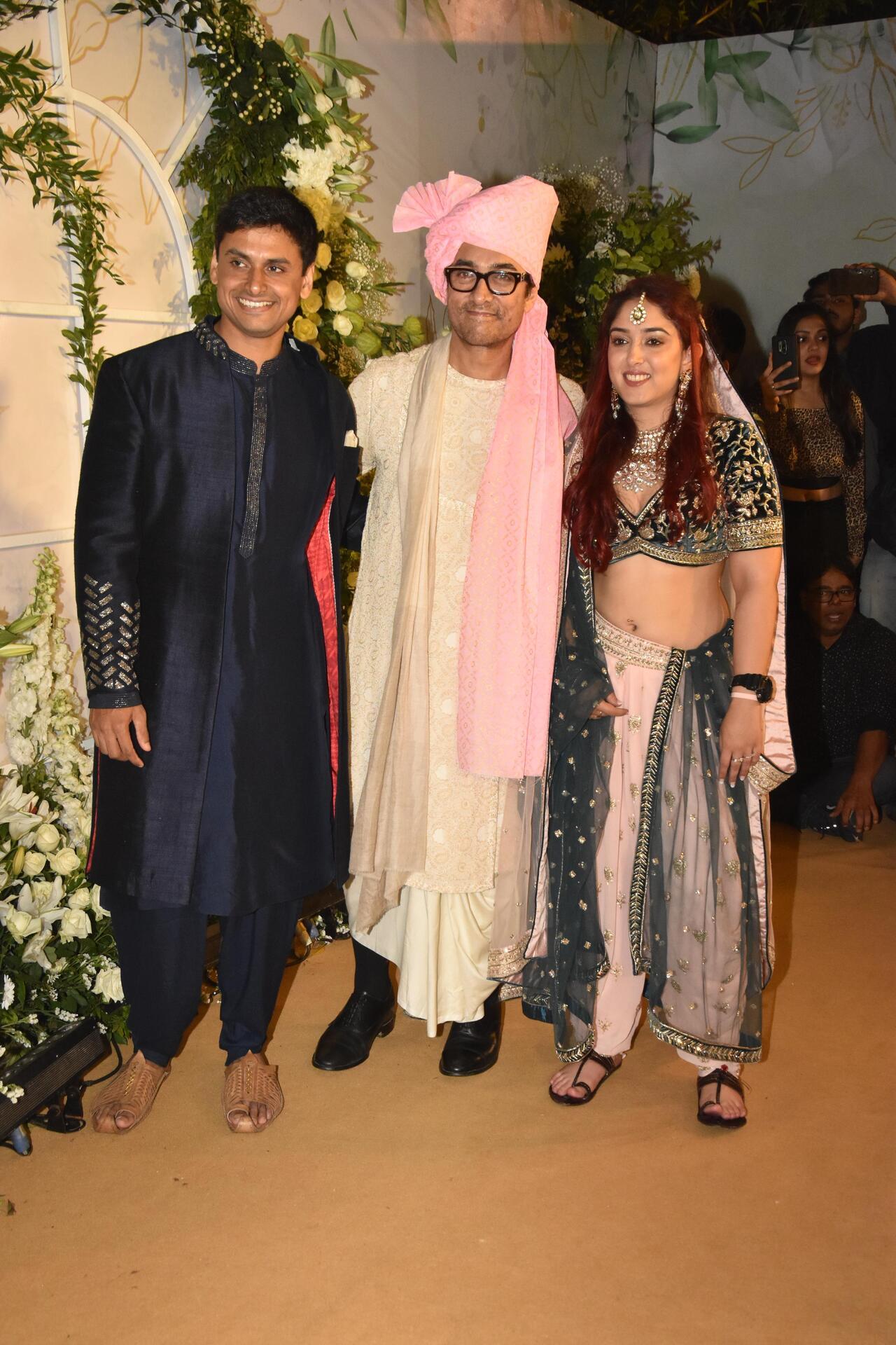 Proud papa Aamir Khan poses with newlyweds Ira Khan and Nupur Shikhare. The couple got married on Wednesday at the Taj Lands Ends in Mumbai 