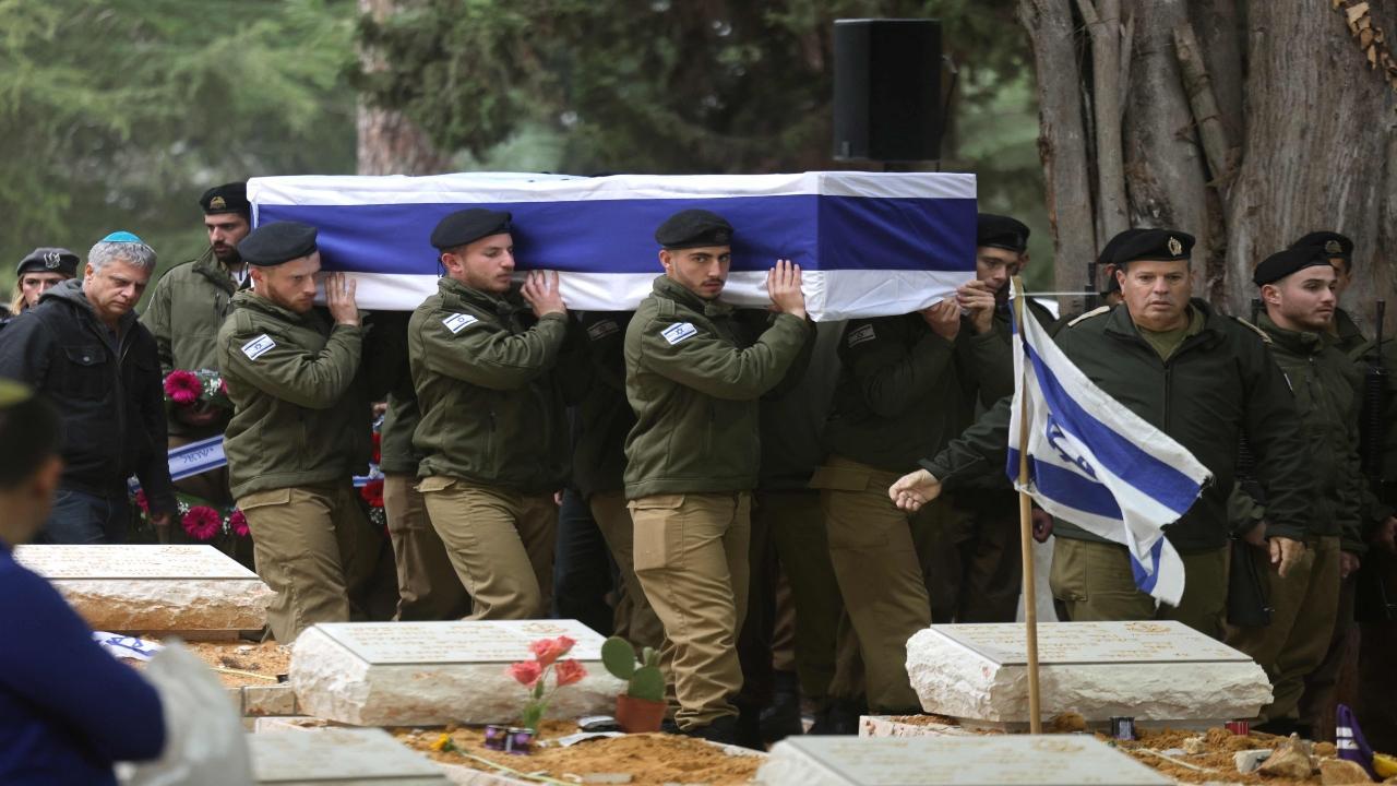Israeli troops carry the coffin of soldier Hadar Kapeluk a day after he was killed in combat in the Gaza Strip amid ongoing battles between Israel and the Palestinian militant group Hamas