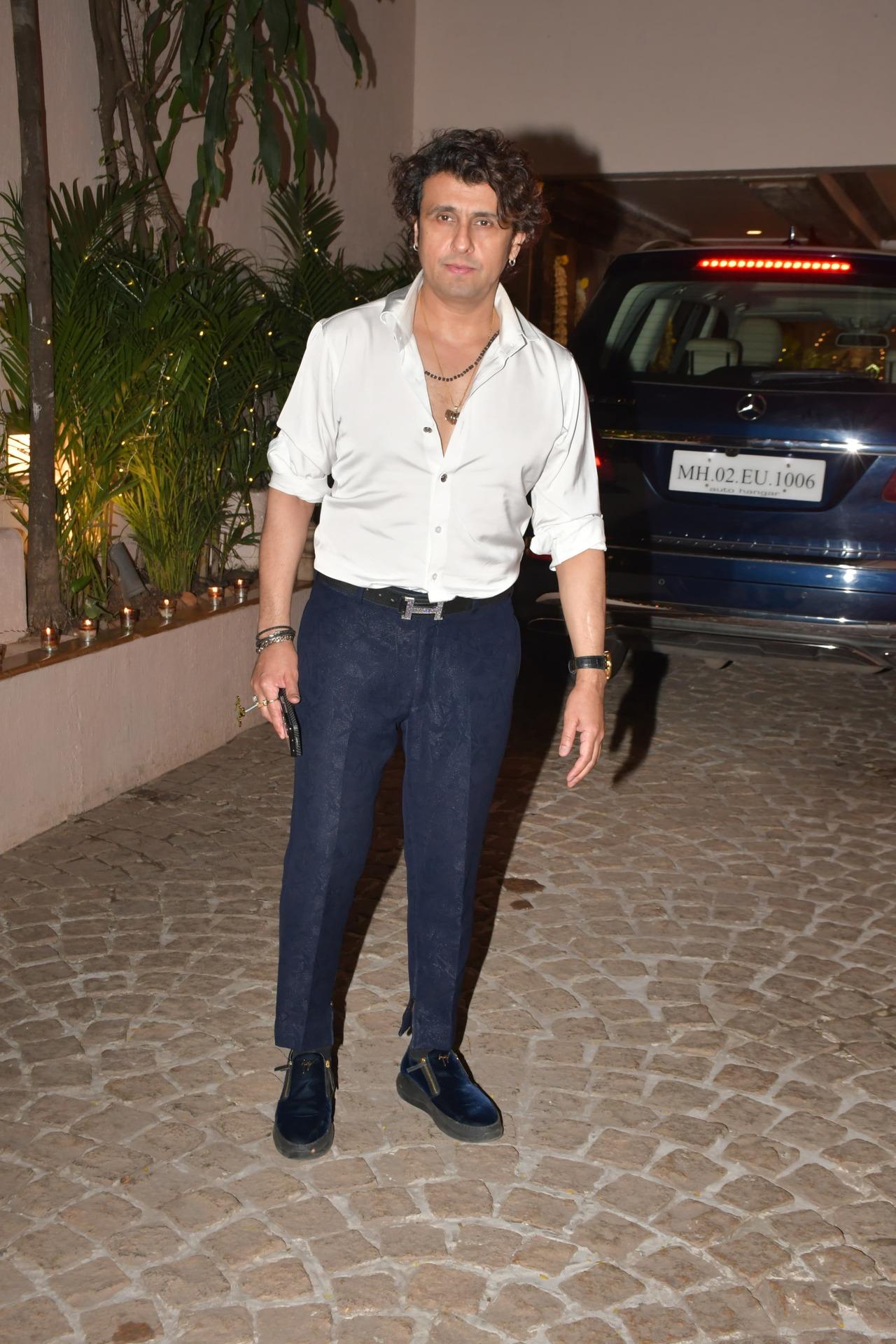 Singer Sonu Nigam looked dapper in a white shirt and blue pants as he arrived for the party