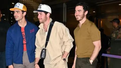 The Jonas Brothers were snapped at the Mumbai airport in the wee hours of the morning. They are here to headline Lollapalooza 2024. Read More