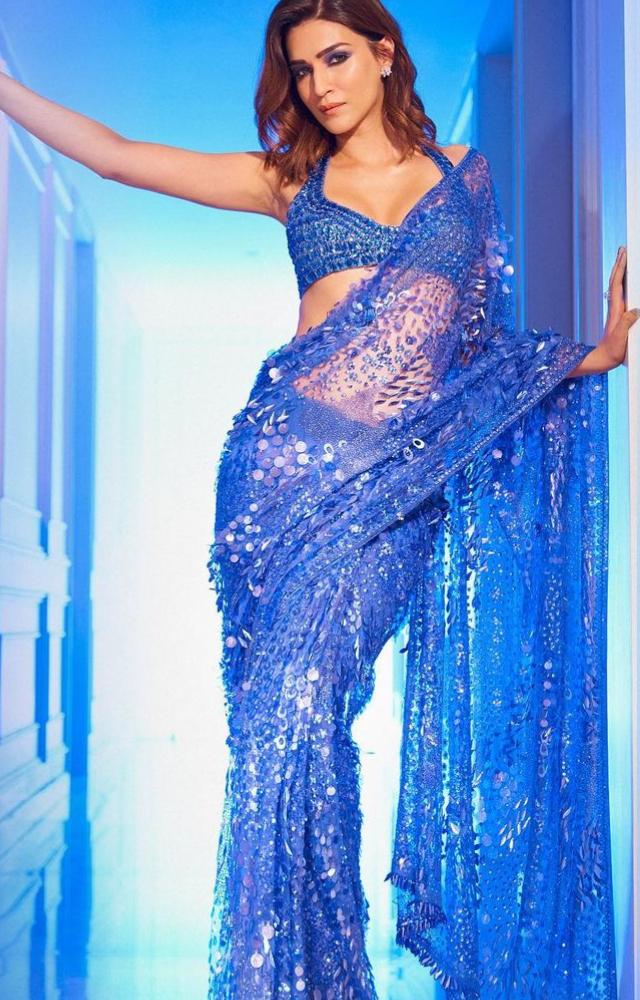 The actress is seen donning a blue net saree with intricate sequin and shimmer embellishments all over and paired the saree with a halter neck blouse