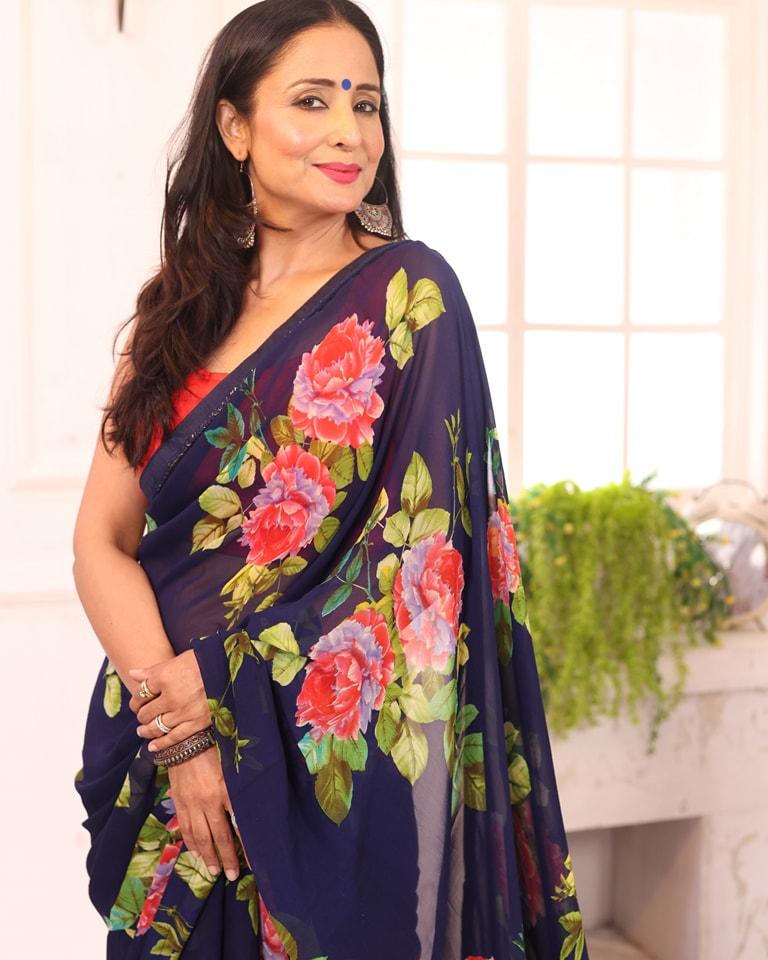 Lataa effortlessly embraces a printed blue saree, exuding charm and elegance