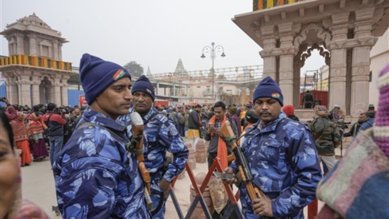 Security personnel stand guard at the entry point for Ram Mandir, ahead of its inauguration ceremony