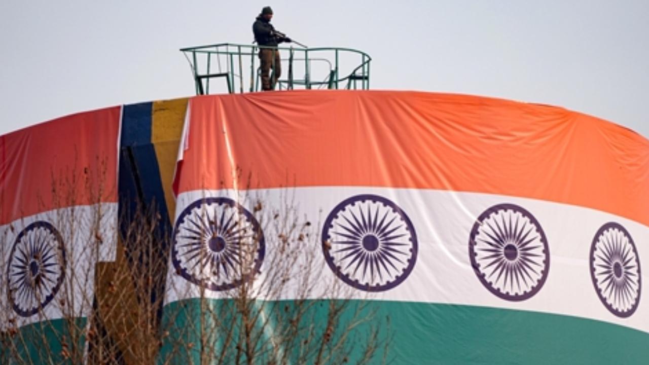 A security official keeps a vigil during full dress rehearsal for the upcoming Republic day celebrations at Bakshi Stadium in Srinagar
