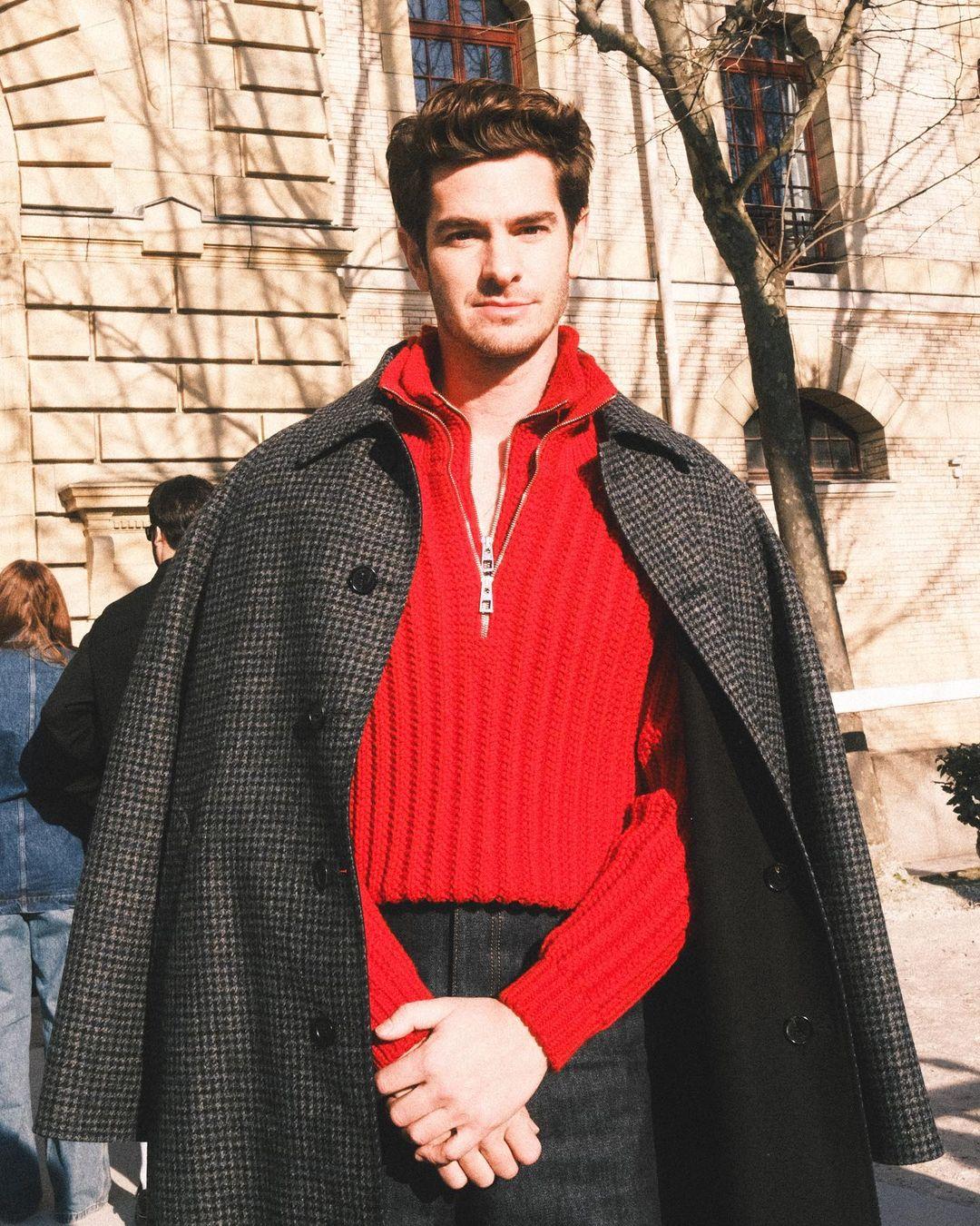 At Paris Fashion Week, Andrew Garfield caught attention with his sharp sense of style. He rocked a stylish outfit, combining a striking red shirt with tailored grey trousers. To add a touch of sophistication, he threw on a sleek grey overcoat.