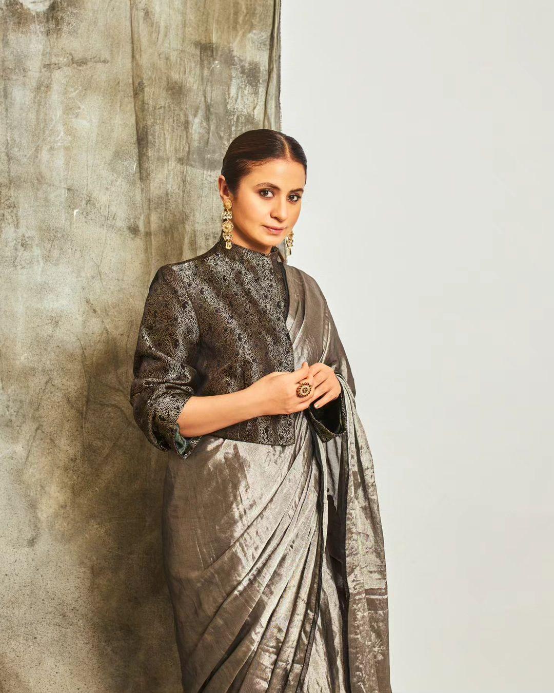 For one of her more sophisticated saree ensembles, Rasika opted for a grey saree paired with a closed, collared blouse featuring half-sleeves. This particular saree was sourced from Raw Mango's wardrobe collection.
