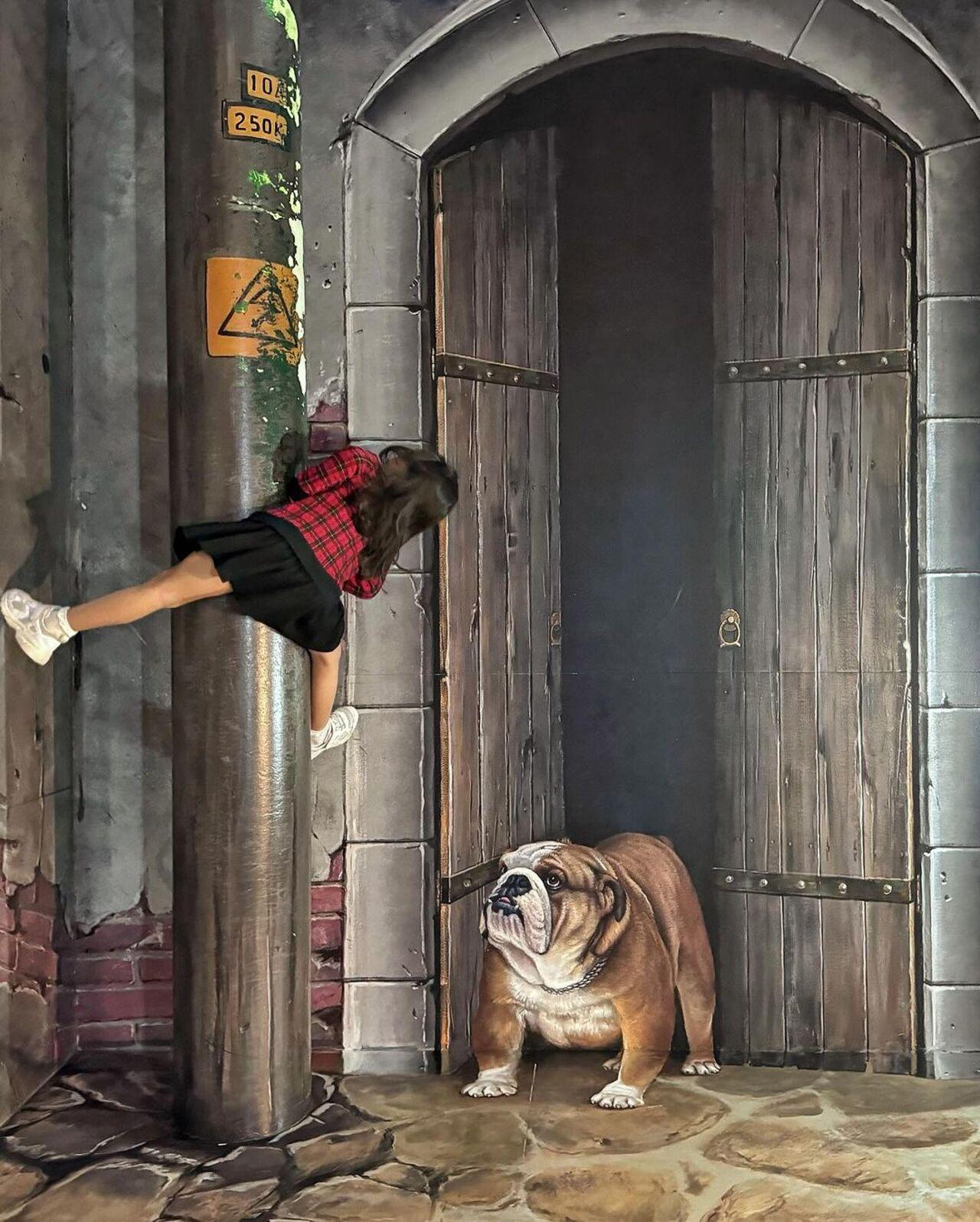 Little Inaaya clings on to dear life in this art depiction of a bulldog scaring the living daylights out of her!