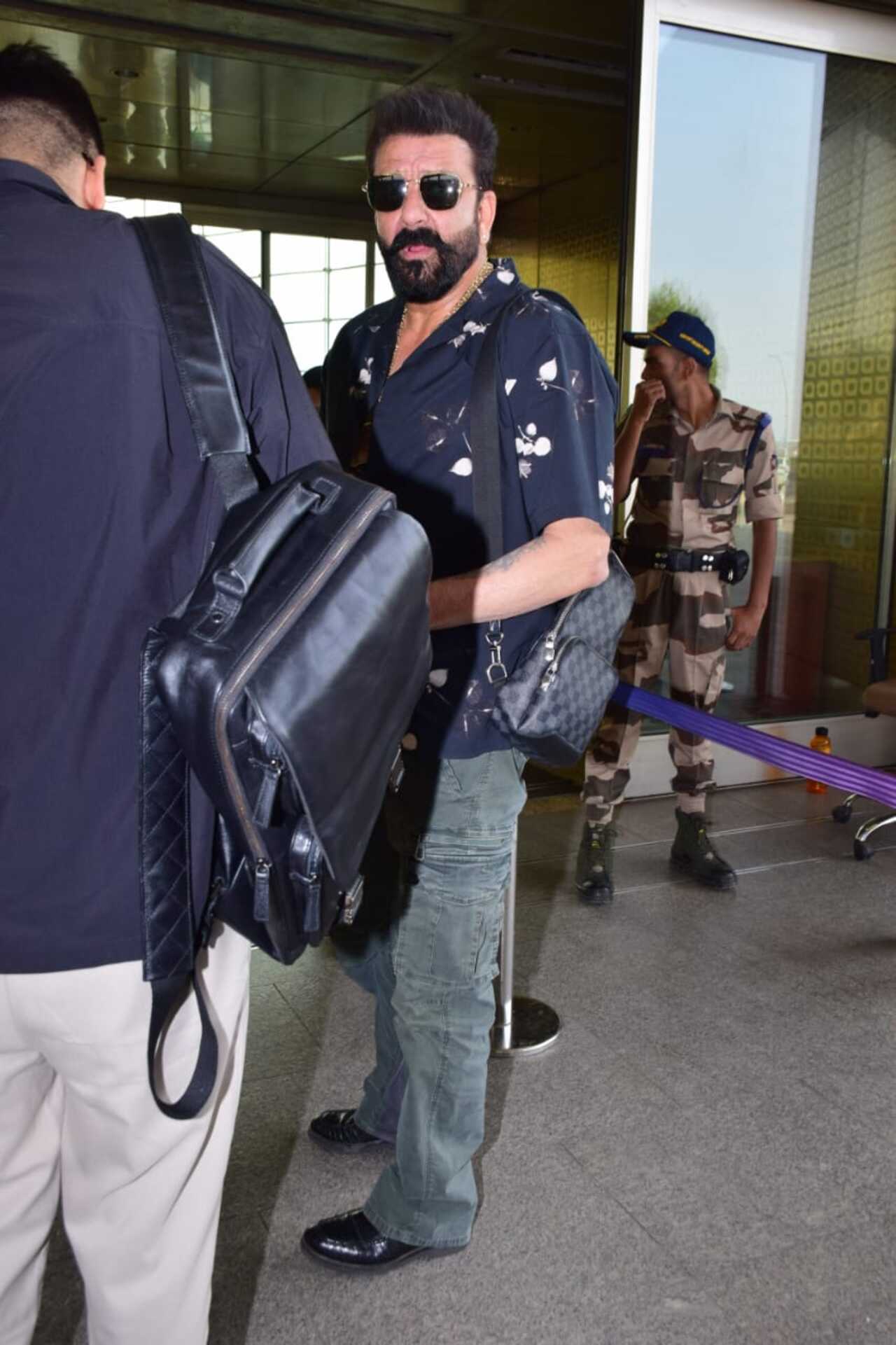 Sanjay Dutt struck a pose for the paparazzi before he walked into the airport