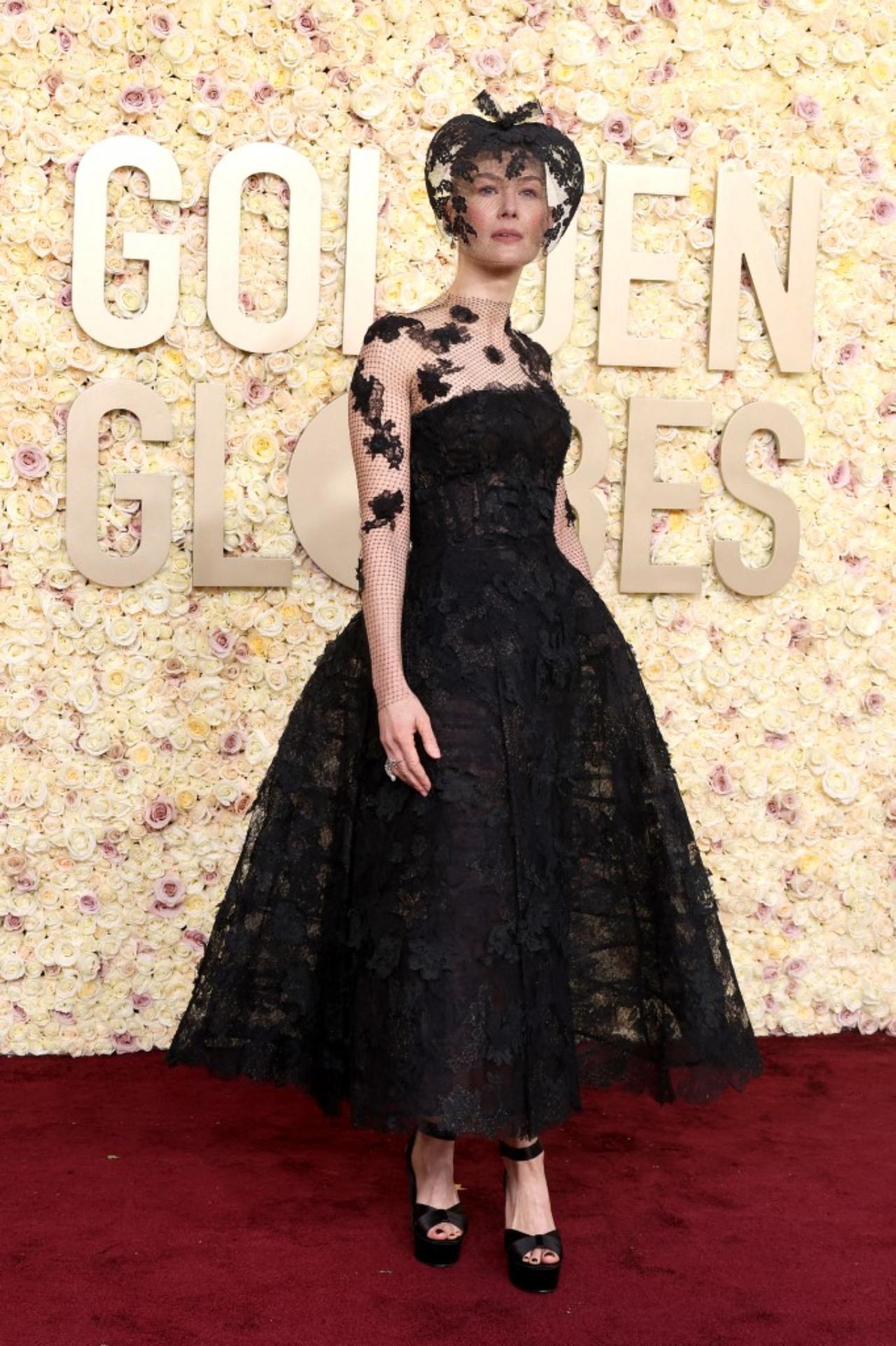 Saltburn actor Rosamund Pike turned her skiing accident that left her 'face smashed' into a fashion win in an eye-catching lace dress and veil at Golden Globes