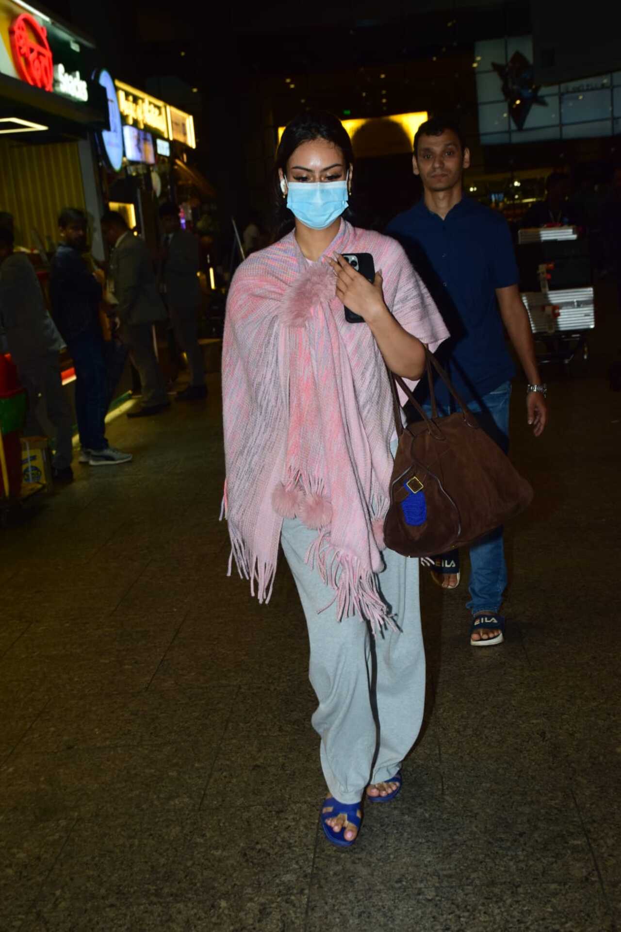 Nysa Devgn was seen in a pink shawl and face mask as she exited the airport