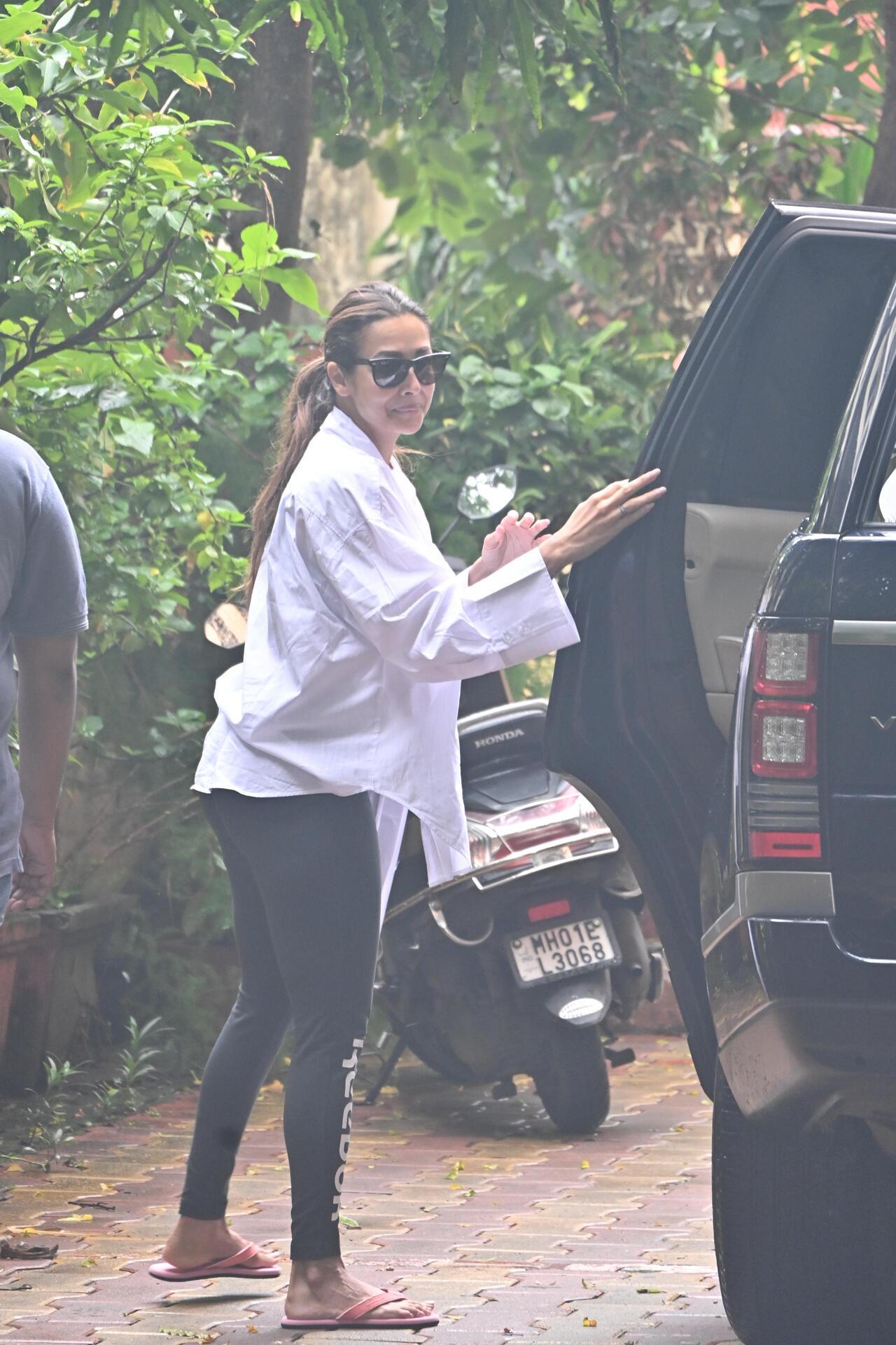 Malaika Arora was spotted in the city in an oversized white shirt and black leggings. She smiled for the paparazzi before making an exit