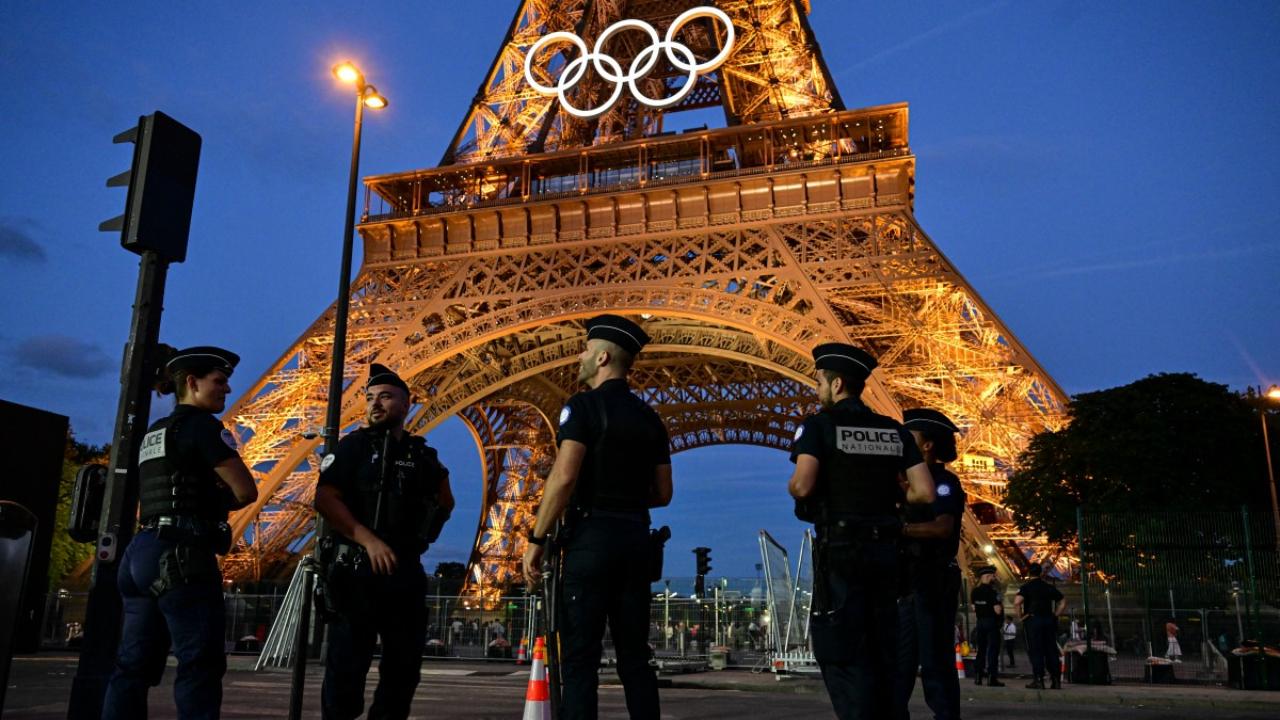 Police officers stand guard near Eiffel Tower in Paris on July 21, 2024, ahead of the Paris 2024 Olympic and Paralympic Games
Around 45,000 members of the French security forces are set to be on duty on Friday when the Olympics kick off at 7:30pm (1730 GMT).