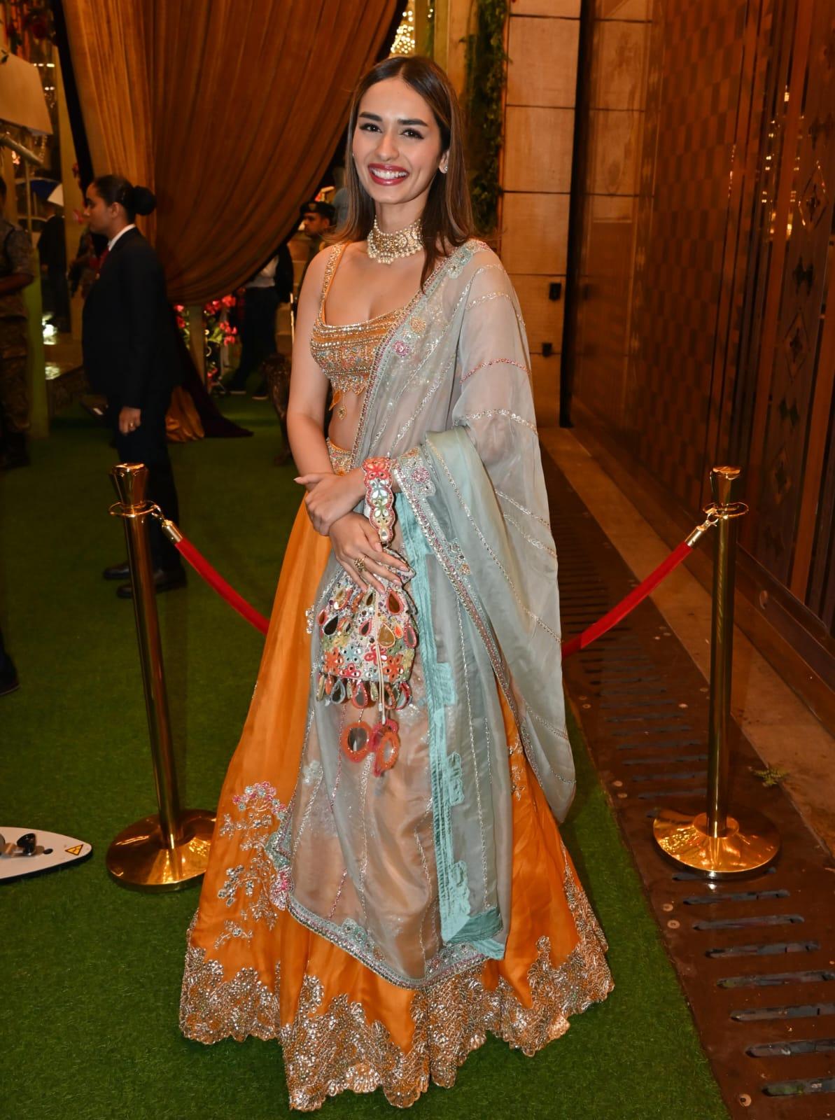 Manushi Chhillar wore an orange lehenga and paired it with an embroidered blouse. The actress paired her stunning lehenga with green duppatta