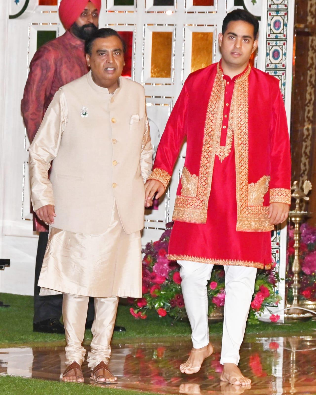 Mukesh Ambani and Akash Ambani posed for the paparazzi at the haldi ceremony