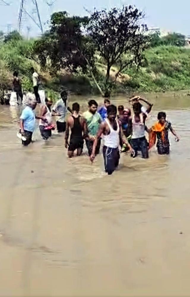 Multiple videos of the situation have surfaced on social media, showing people wading through waist-deep water lugging cylinders