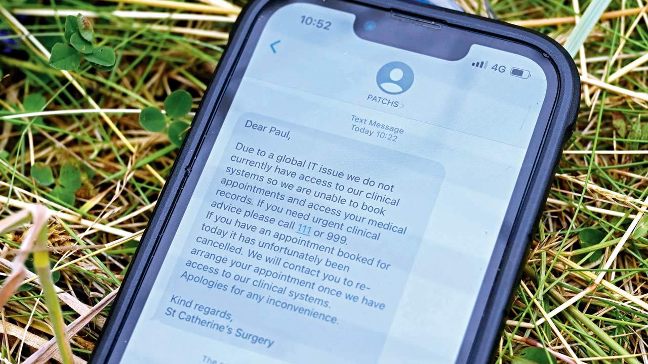 A mobile phone displays a text message alert from a British NHS doctor telling a patient his appointment could not be registered, on Friday. Pics/AFP